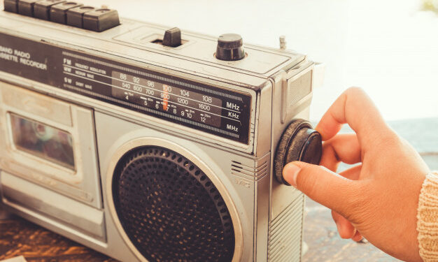 woman-s-hand-adjusting-button-vintage-radio_1484-1362-626x375